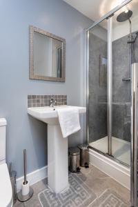 a bathroom with a sink and a shower at Stylish Three Bed House Burnley in Burnley