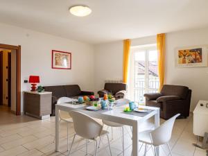 a living room with a white table and chairs at Apartment Raggio di Sole Apartment A and B by Interhome in Consiglio di Rumo