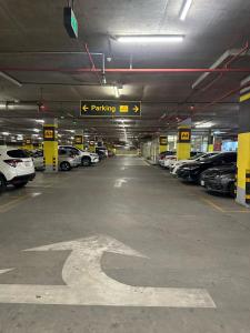 a parking garage with cars parked in it at Mirhaa Homes # 1 -Gold Crest Mall One Bed Apartment By Dr - Subhan Shahid in Lahore