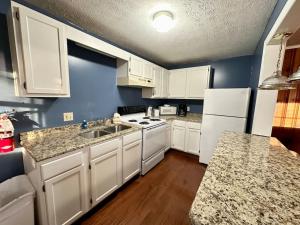a kitchen with white cabinets and a white stove top oven at Cottage 5- Lees Ford Marina in Nancy