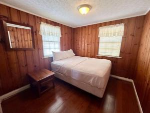 a bedroom with a bed and a table in it at Cottage 1- Lees Ford Marina in Nancy