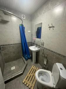 a bathroom with a toilet and a sink at May Weather Resort in Bukhara