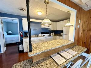 a kitchen with a table with a counter top at Cottage 8Lees Ford Marina in Nancy