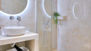 a bathroom with a sink and a shower at Loutsiana Apartments Corfu in Alykes Potamou +17 photos