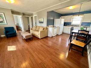 a living room with a couch a table and a kitchen at Cottage 16 Lees Ford Marina in Nancy