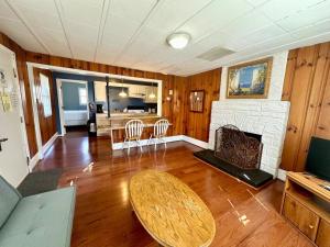 a living room with a table and a fireplace at Cottage 8Lees Ford Marina in Nancy