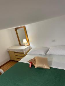 CASA VACANZE CANAL GRECO - B&B في كاستروفيلاري: غرفة نوم مع سريرين ومرآة وسرير sidx sidx