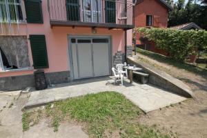 a patio with a table and chairs in front of a house at B&B Località Manzoniane in Lecco