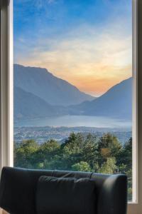 a couch sitting in front of a window with a view at Dolada Boutique Hotel in Staol