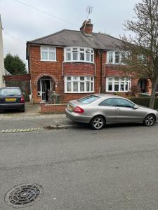 a silver car parked in front of a house at Leicester UK Room 2 Edward House in Leicester