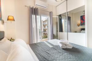 a bedroom with a bed and a large mirror at Tennis View Apartment in Agios Rokkos +24 photos