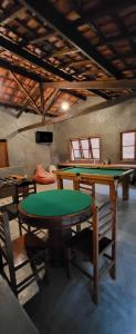 a room with a ping pong table and chairs at Pousada do Coura in Pouso Alto