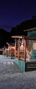a row of houses at night with lights at Pousada do Coura in Pouso Alto