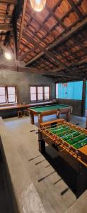 a large room with a pool table in it at Pousada do Coura in Pouso Alto