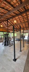 an empty gym with a wooden ceiling and beams at Pousada do Coura in Pouso Alto