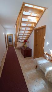 a attic room with a bed and a staircase at Penzion Duncan in Janske Lazne