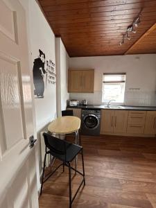 a kitchen with a table and a chair and a table at 1 Newcastle Street in Crewe