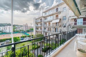 a balcony with a view of a city at Tennis View Apartment in Agios Rokkos