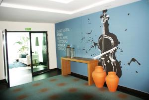 a room with a wall with a violin painted on it at Beramar Hotel in Praia