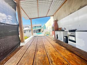 a wooden table in a kitchen with a view at Dellas Pousada in Maragogi