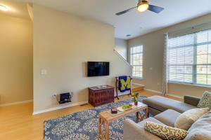 a living room with a couch and a tv at Michigan Townhome with Smart TV 25 Mi to Detroit! in Grand View Acres