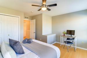 a bedroom with a white bed and a ceiling fan at Michigan Townhome with Smart TV 25 Mi to Detroit! in Grand View Acres