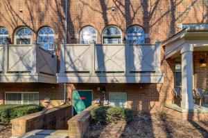 a brick building with two balconies on it at Michigan Townhome with Smart TV 25 Mi to Detroit! in Grand View Acres