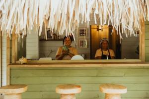 two women are looking in the mirror in a restaurant at Agua de Luna in Puerto Limón
