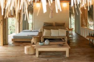 a bedroom with a bed and a table in it at Agua de Luna in Puerto Limón +30 photos