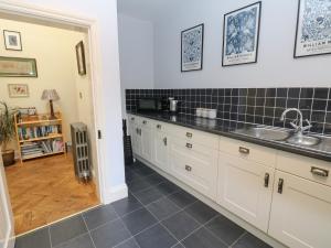 a kitchen with a sink and a counter at Plum Tree Cottage in Castleton +20 photos