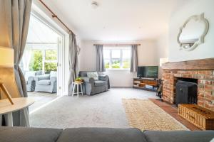 a living room with a couch and a fireplace at Brambles in Brancaster