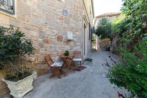 an alley with chairs and a table and a building at Villa Old Town in Šibenik