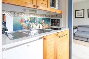 a kitchen with a sink and a stove at Studio au calme quartier Port Olona Les Sables 4 personnes in Les Sables-dʼOlonne