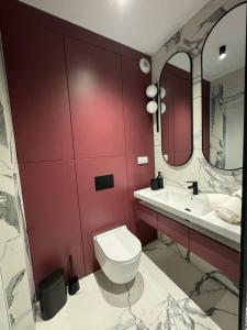 a bathroom with a white toilet and a sink at Penthouse21 in Oświęcim +16 photos