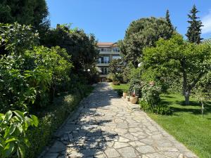 a stone path in front of a building at Paneon Apartments in Iraklitsa