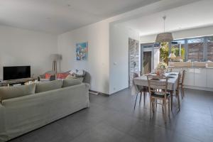 a living room with a couch and a dining room at 500m Plage des Libraires - Maison 4 chambres in Pornichet