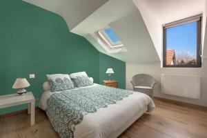a bedroom with a large bed and a window at 500m Plage des Libraires - Maison 4 chambres in Pornichet +17 photos