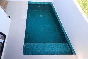 a swimming pool in a house with blue water at Cozy Pool Villa near SM Pampanga and Sky Ranch Pampanga in San Fernando