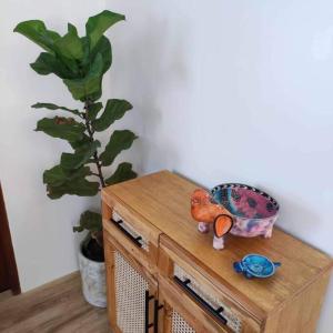 a wooden table with a plant and a bowl on it at Cozy Pool Villa near SM Pampanga and Sky Ranch Pampanga in San Fernando