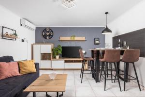 a living room with a couch and a table at MLADENKA apartment in Kraljevica
