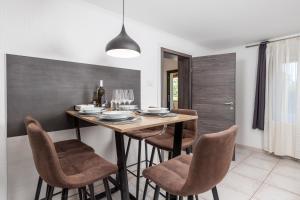 a dining room with a table and chairs at MLADENKA apartment in Kraljevica