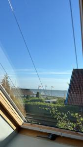 a view of the ocean from the window of a house at Bangomūša in Nida