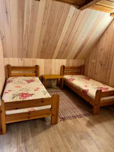 - 2 lits dans une chambre dotée de plafonds en bois dans l'établissement Latkrantė, à Latežeris