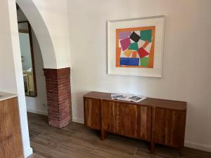 a room with a table and a painting on the wall at Maison d'Orange - La Pinede in Saint-Tropez