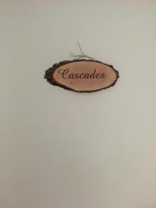 a sign that says excellence hanging on a wall at Aux Lacs et Cascades in Songeson