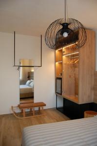 a bedroom with a room with a bed and a table at MIRANDOLINA Bed and Breakfast in Rocca di Cambio