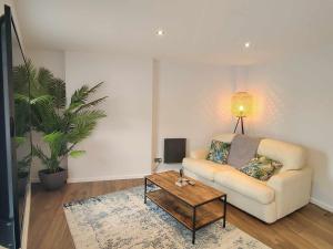 a living room with a couch and a coffee table at Queen's Apartment in Cardigan, Cardigan Bay in Cardigan
