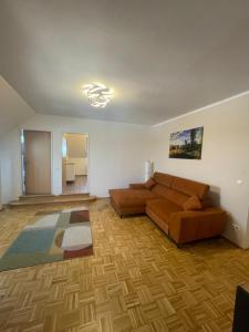 a living room with a couch and a rug at BullsLiving Seeapartment 4 AM CORSO in Velden am Wörthersee
