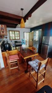 a kitchen with a wooden table and chairs in a room at Casa Berta in Puerto Viejo