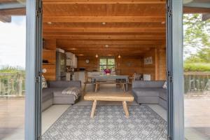 a living room with a couch and a table at Wood Cabin 2 At Tapnell Farm in Yarmouth +20 photos